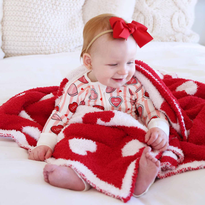 sweet like candy pink convertible zip romper pajama for girls with a coordinating red and white heart microfiber blanket 