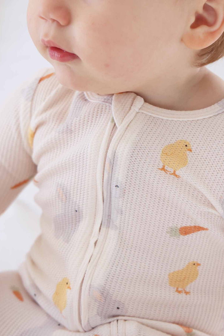 closeup of bamboo waffle zipper footie with chicks, carrots and bunnies 