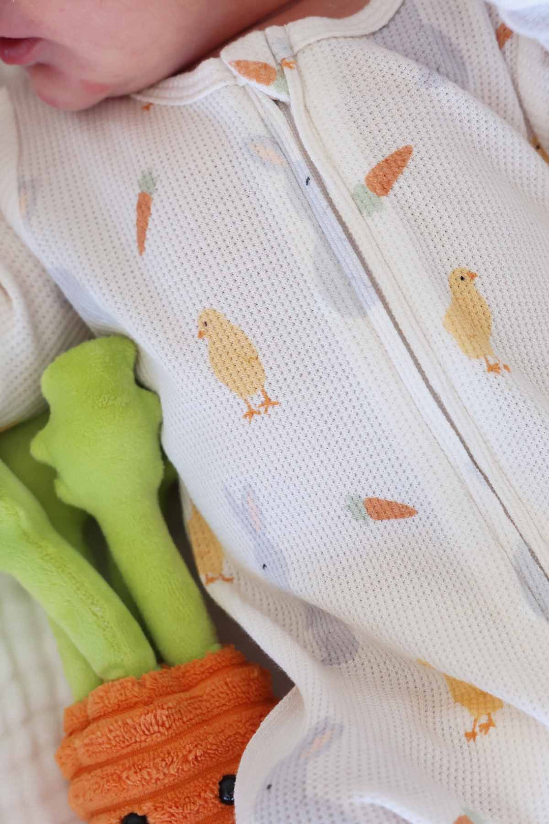 closeup of sweet peep bamboo waffle easter footie pajama with chickadees, carrots and bunnies 