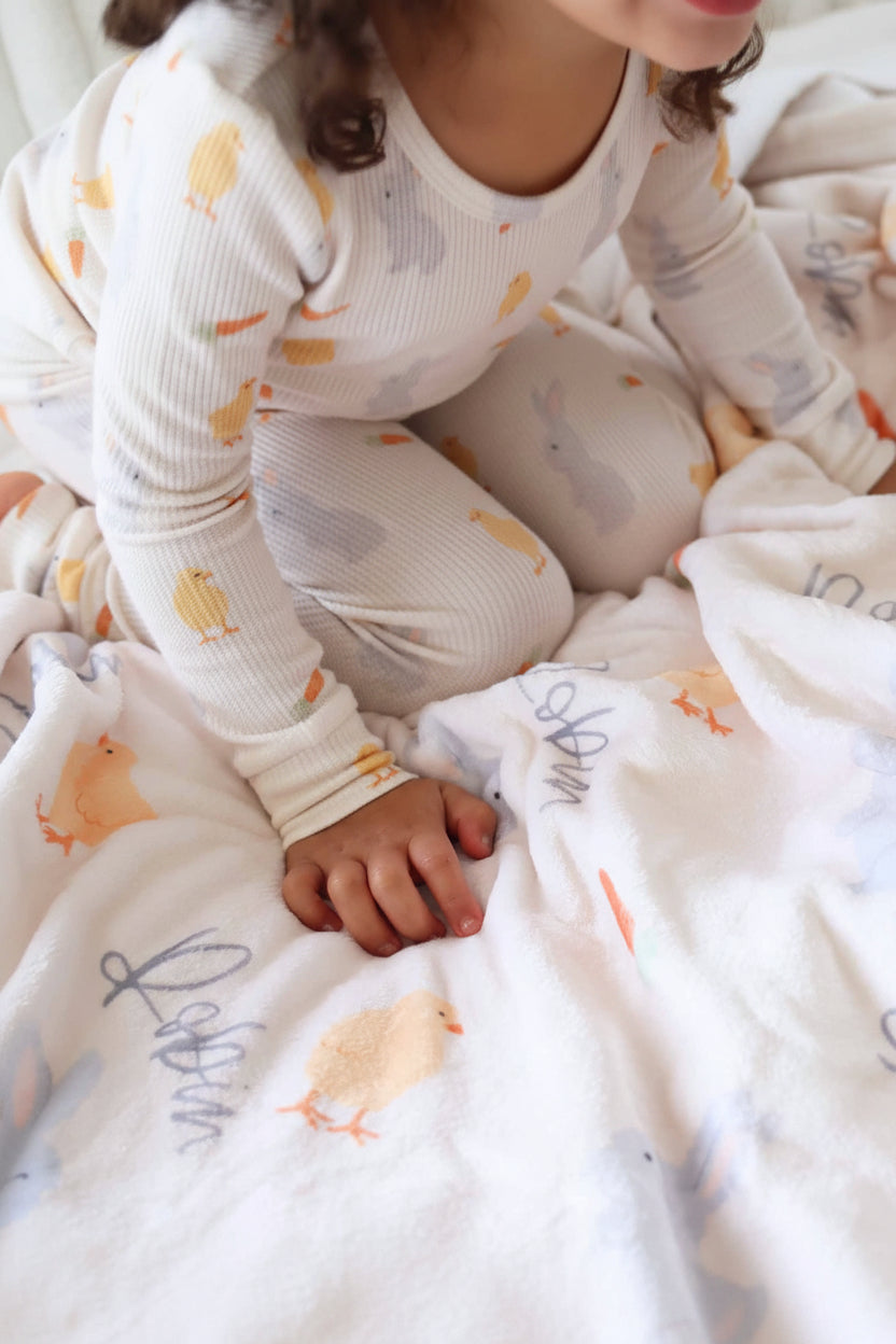 white personalized kids blanket with chicks, bunnies and carrots and matching two piece pajama set 