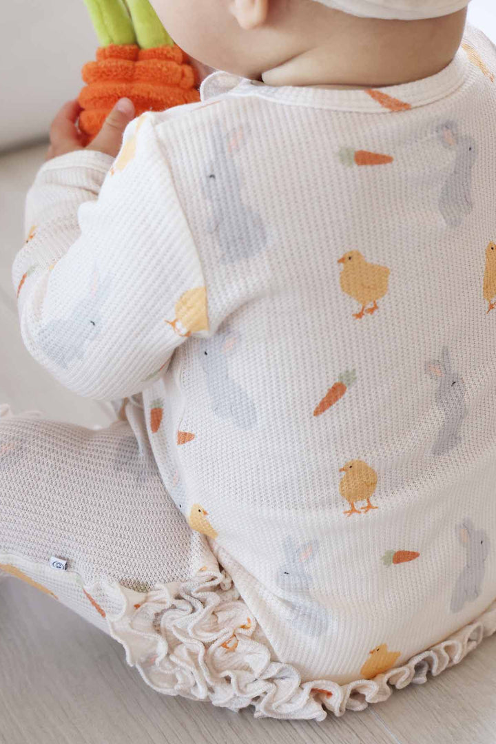 closeup of bamboo waffle peep, bunny and carrot ruffle zipper footie for baby girls 