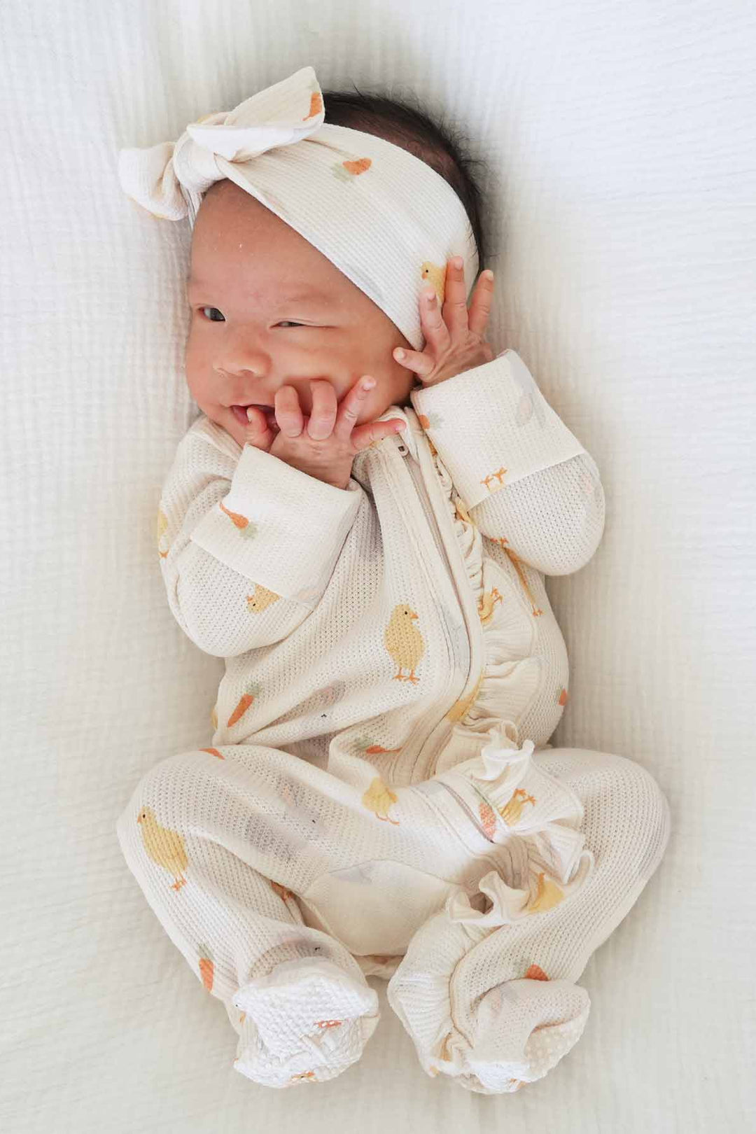 newborn girl in sweet peep waffle ruffle zipper footie 