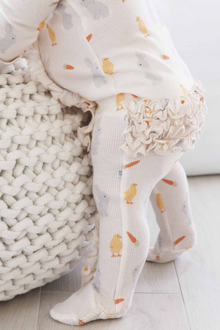 neutral easter bamboo waffle ruffle zipper footie with chicks, carrots and bunnies 
