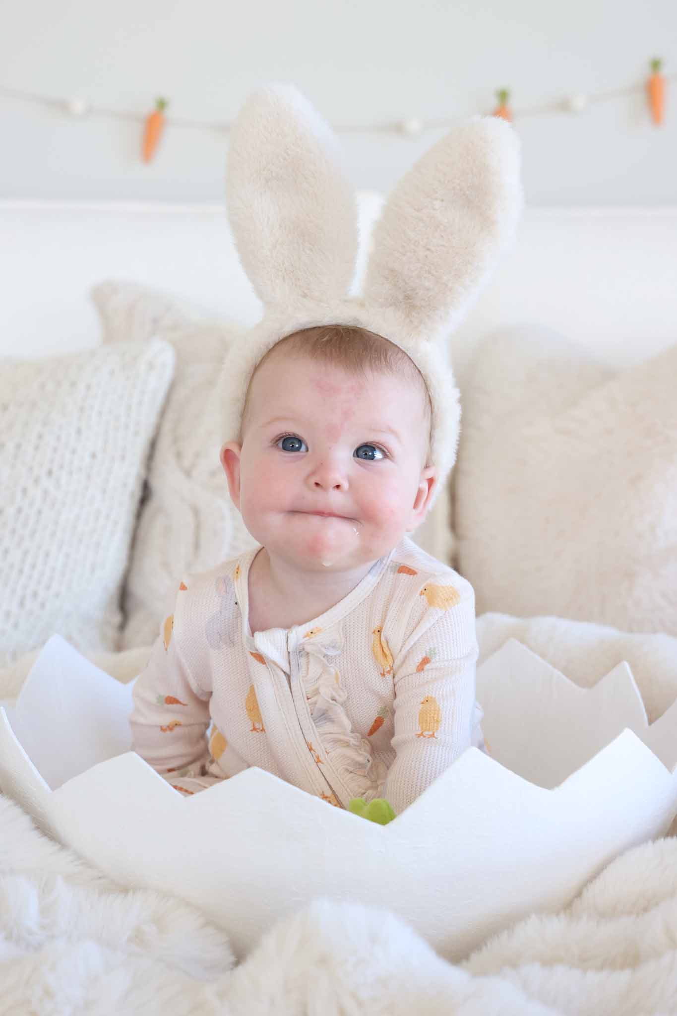 baby sitting in egg wearing sweet peep footie with bunny ears 