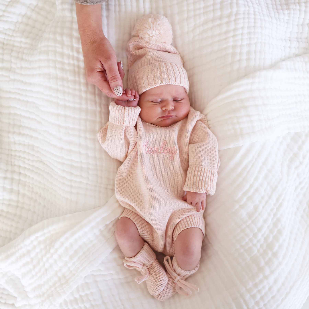 tea rose long sleeve knit sweater romper for baby girls with matching pom pom beanie and knit booties 