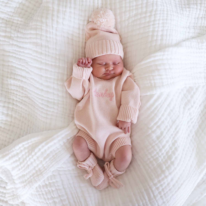 long sleeve light pink embroidered knit sweater romper set with matching pom pom beanie and booties 