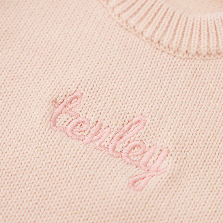 tea rose long sleeve knit sweater romper with light pink thread in script font 