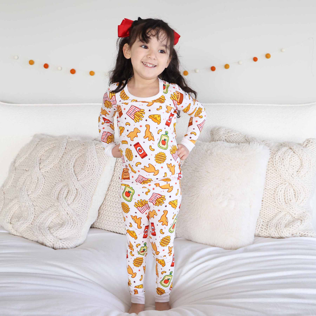 girl wearing a fast food themed bamboo viscose two piece pajama set 