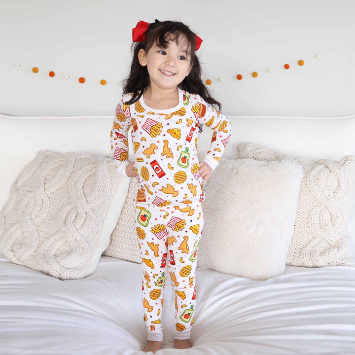 girl wearing a fast food themed bamboo viscose two piece pajama set 