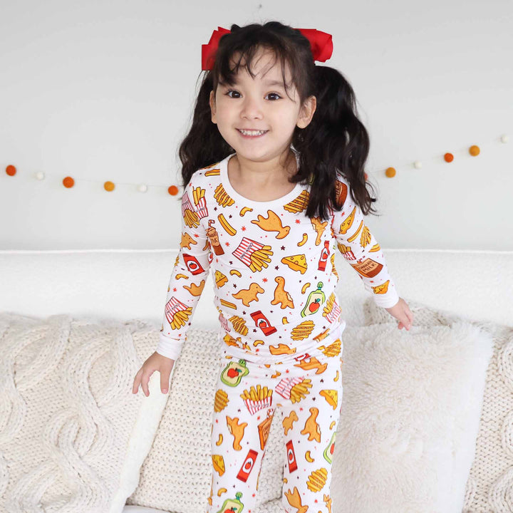 girl wearing fast food themed two piece pajama set 