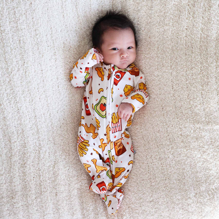 baby laying down wearing a fast food baby footie 