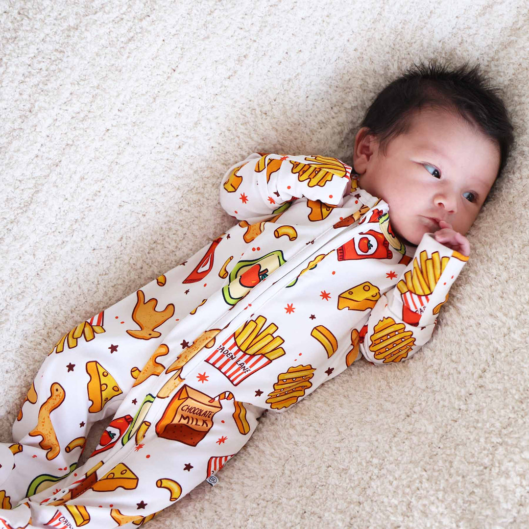 gender neutral baby footie pajama with macaroni, chicken nuggets, chocolate milk, applesauce and more 