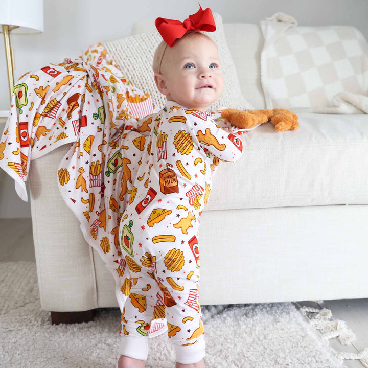 little girl standing wearing tiny bites convertible zip romper 