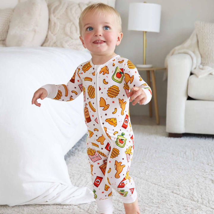 little boy standing wearing tiny bites convertible zip romper pajama 