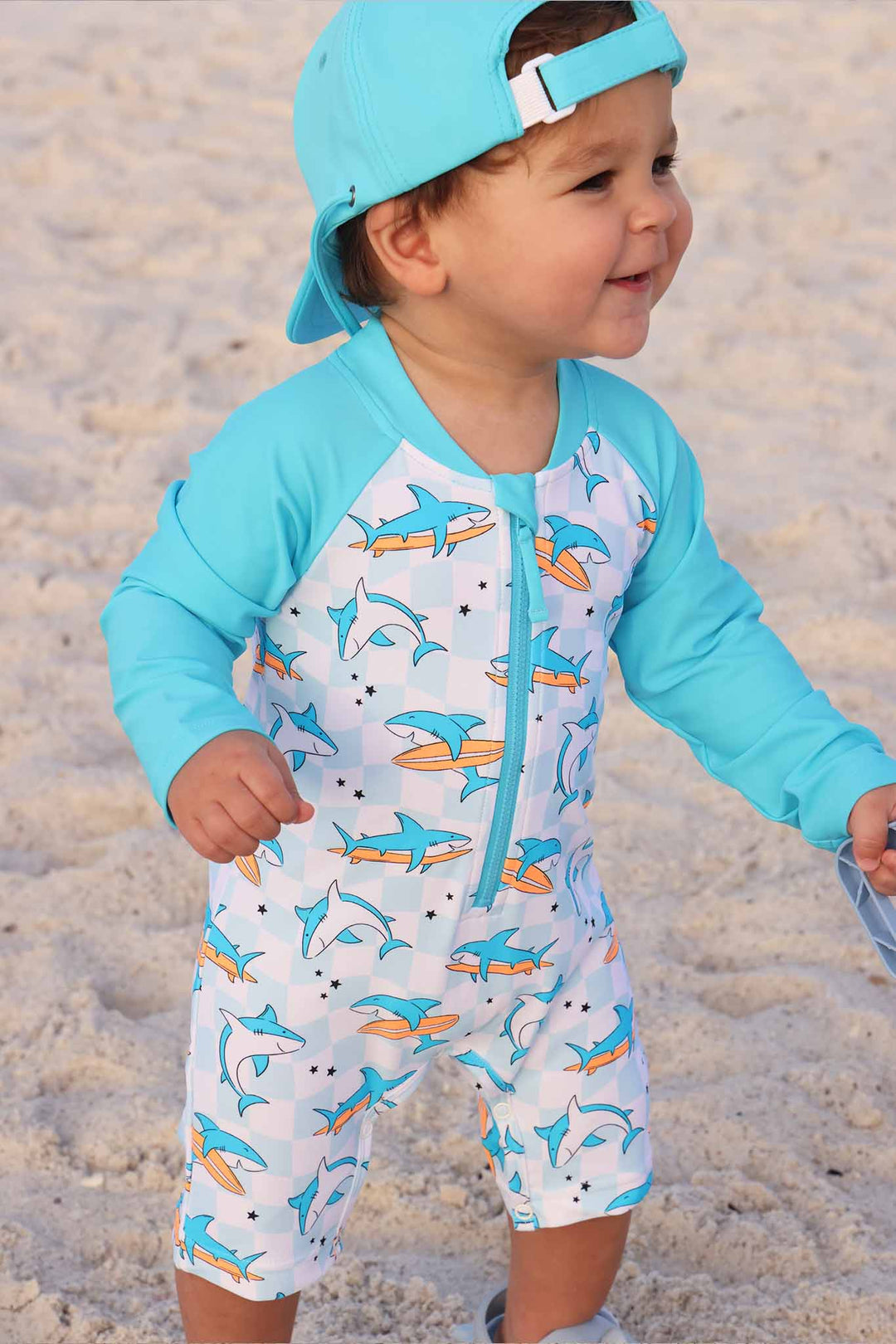 totally jawsome swim romper with long sleeves and matching backwards surf hat 