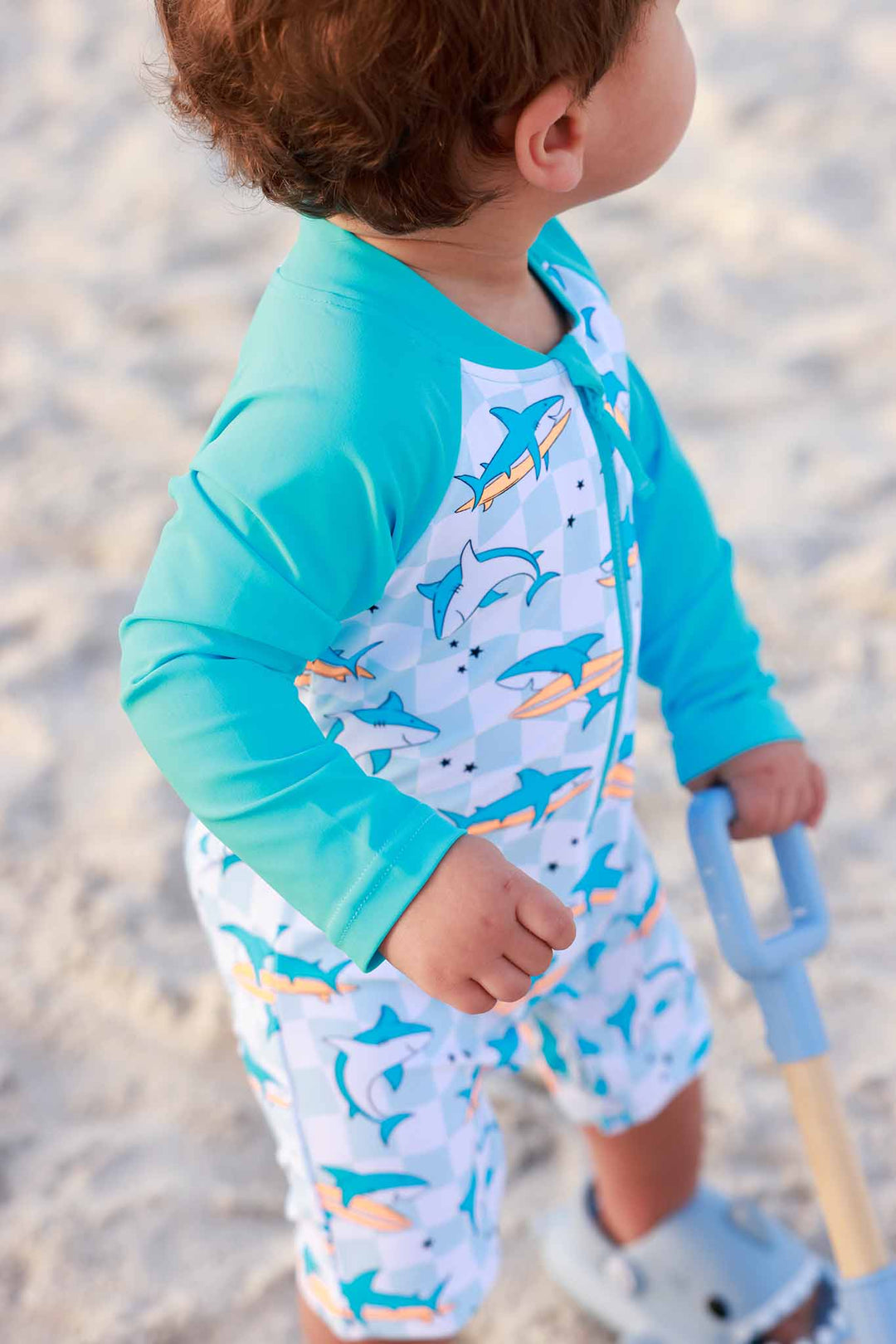closeup of teal sleeve surfing shark swim romper shortie 