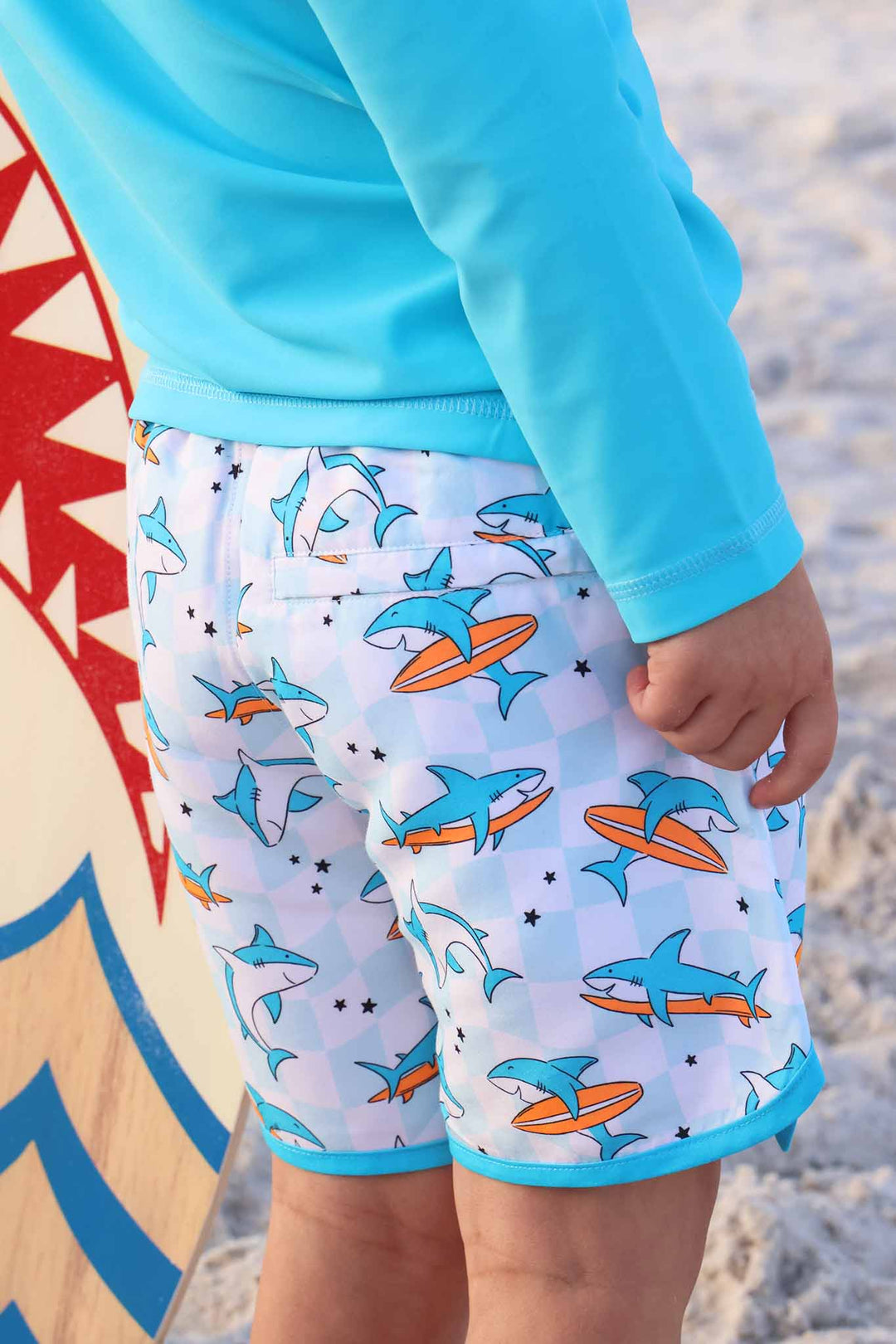 closeup of surfing shark swim trunks for boys 