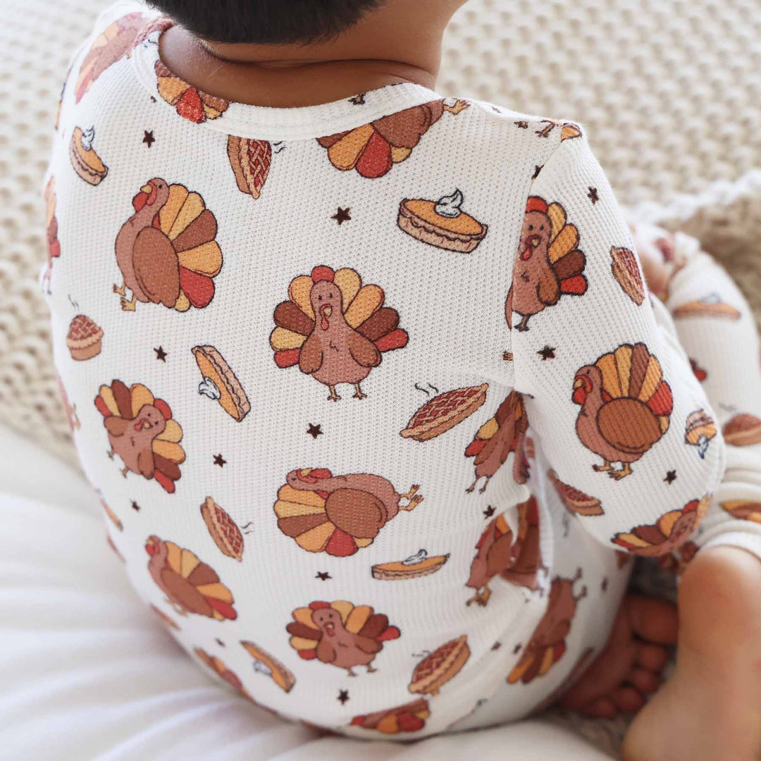 bamboo waffle thanksgiving pajamas for kids with brown turkeys with brown, red and yellow feathers surrounded by steaming pumpkin pies