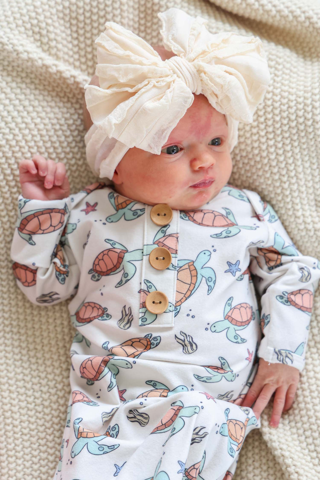 turtley rad bamboo knot gown on a baby – gender neutral turtle print