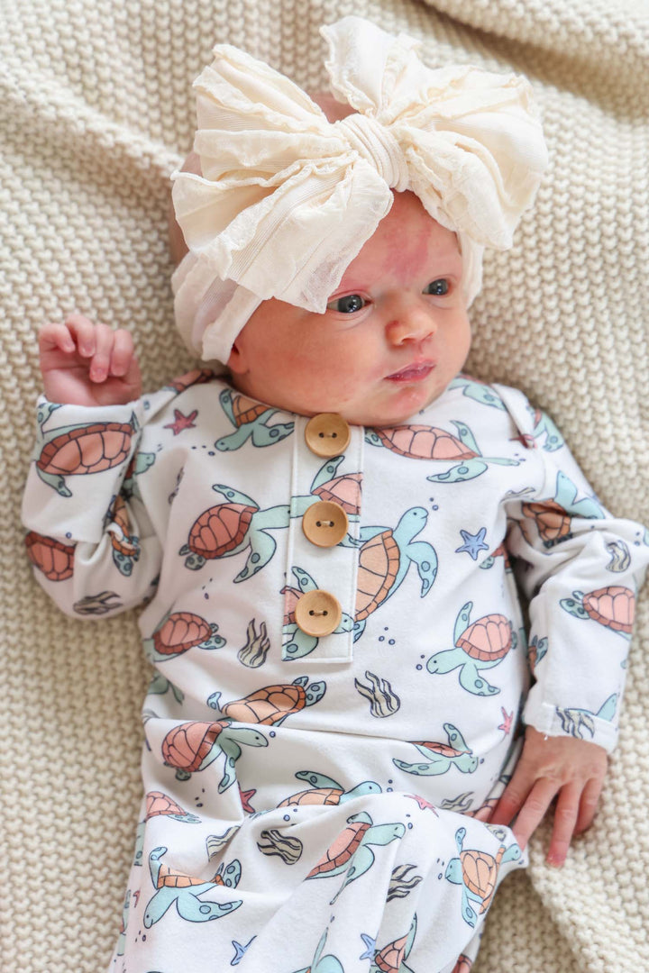 turtley rad bamboo knot gown on a baby – gender neutral turtle print