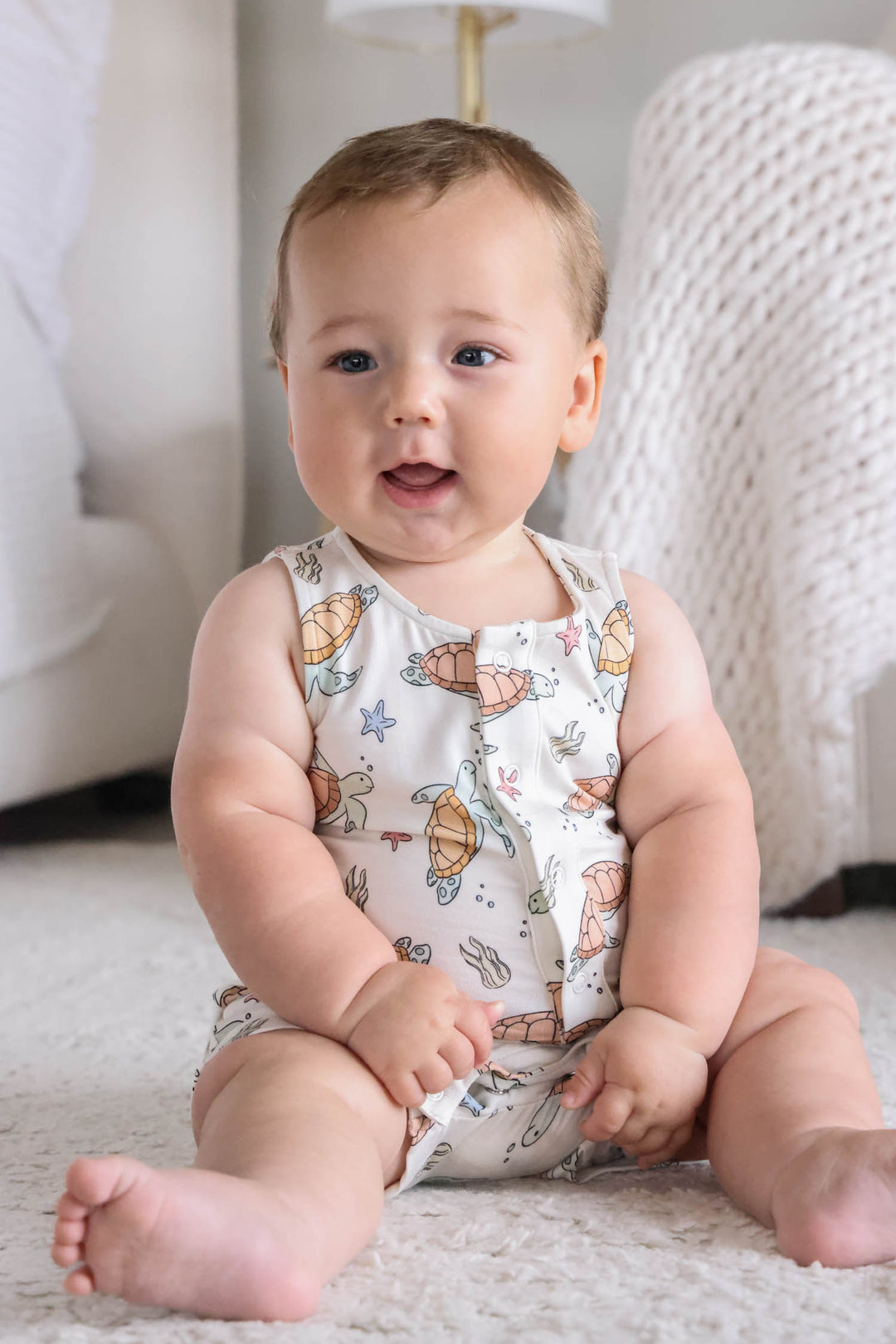 turtley rad bamboo sleeveless snap romper on a baby – gender neutral turtle print