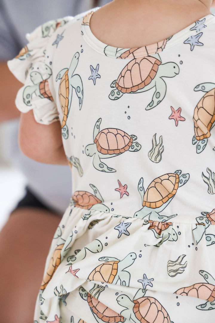 close-up of turtley rad turtle print on bamboo fabric – playful gender neutral design
