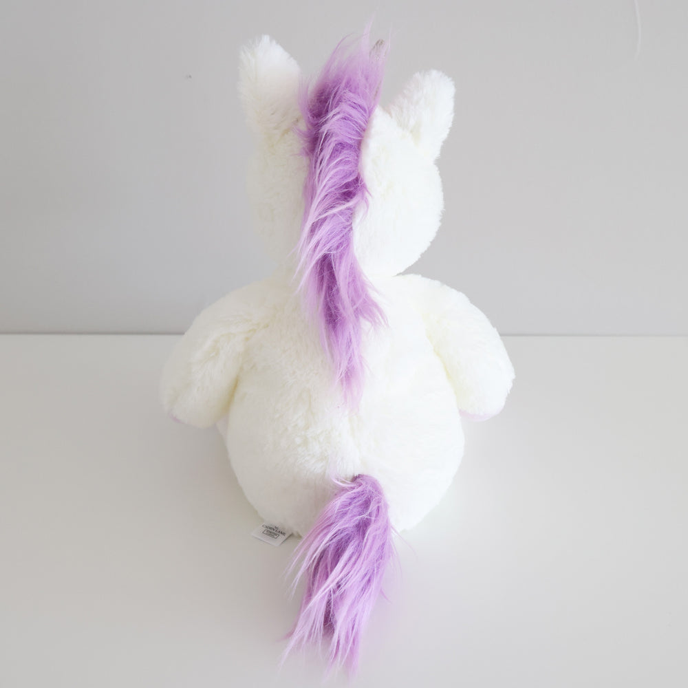 white unicorn stuffed animal with purple tail and mane 