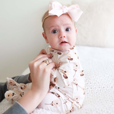 ruffle zipper footie for babies with neutral floral