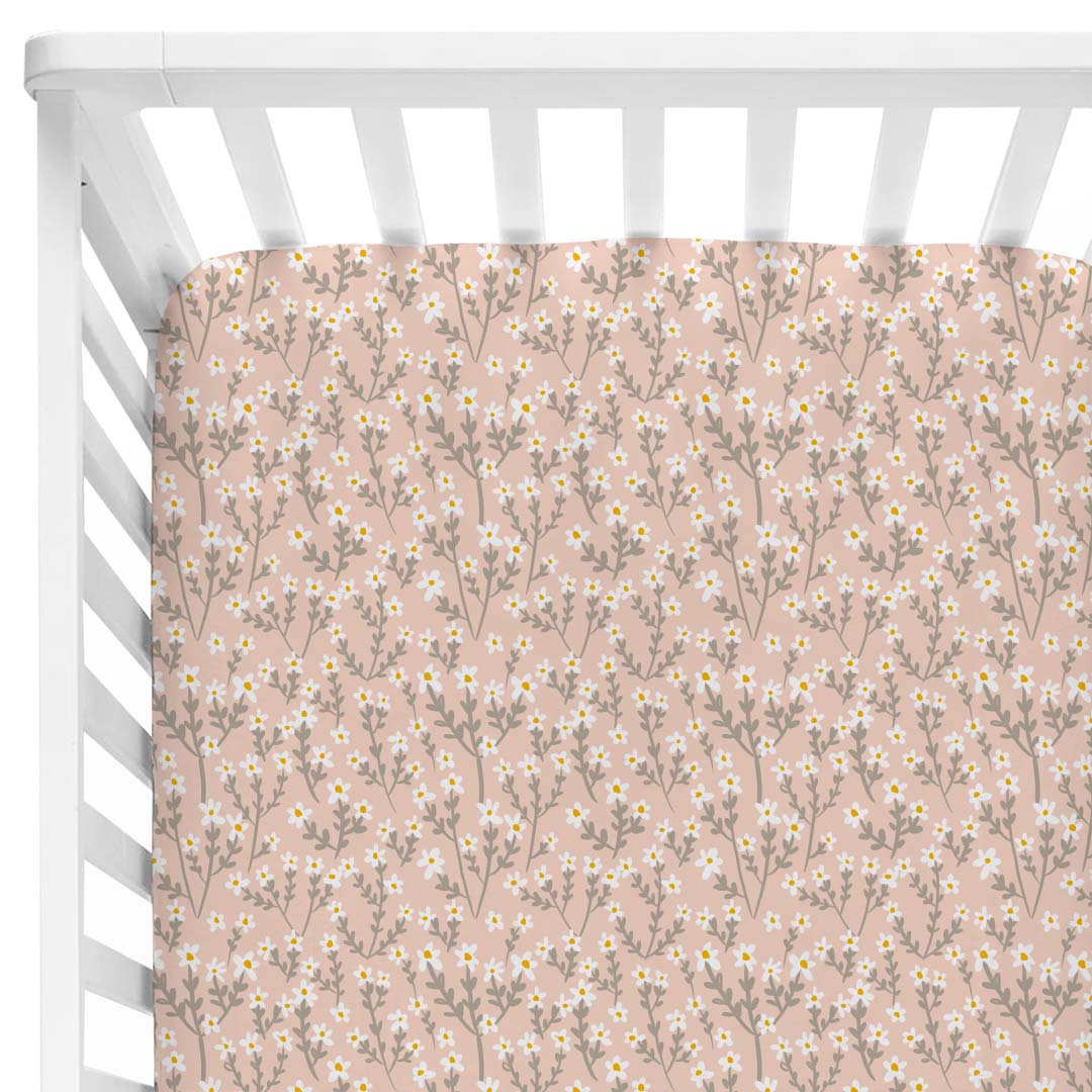 pink crib sheet with white flowers