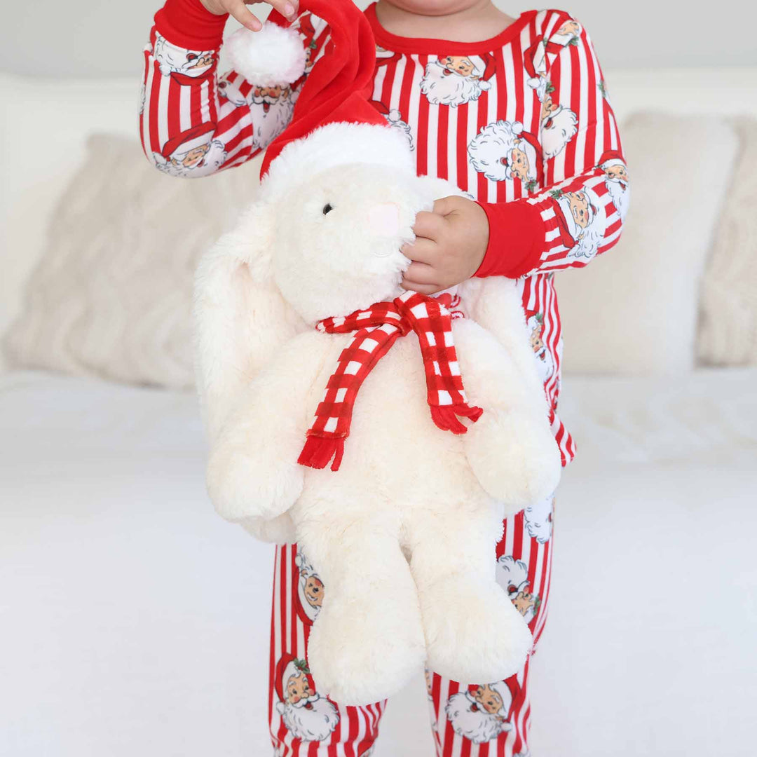 floppy eared bunny stuffed animal dressed in christmas accessories 