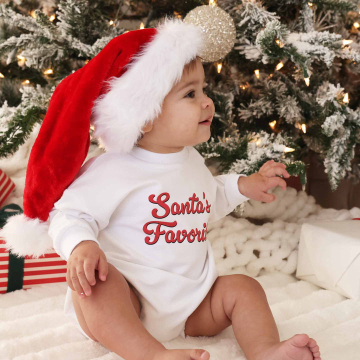 baby boy wearing white sweatshirt bubble romper that says santa's favorite 